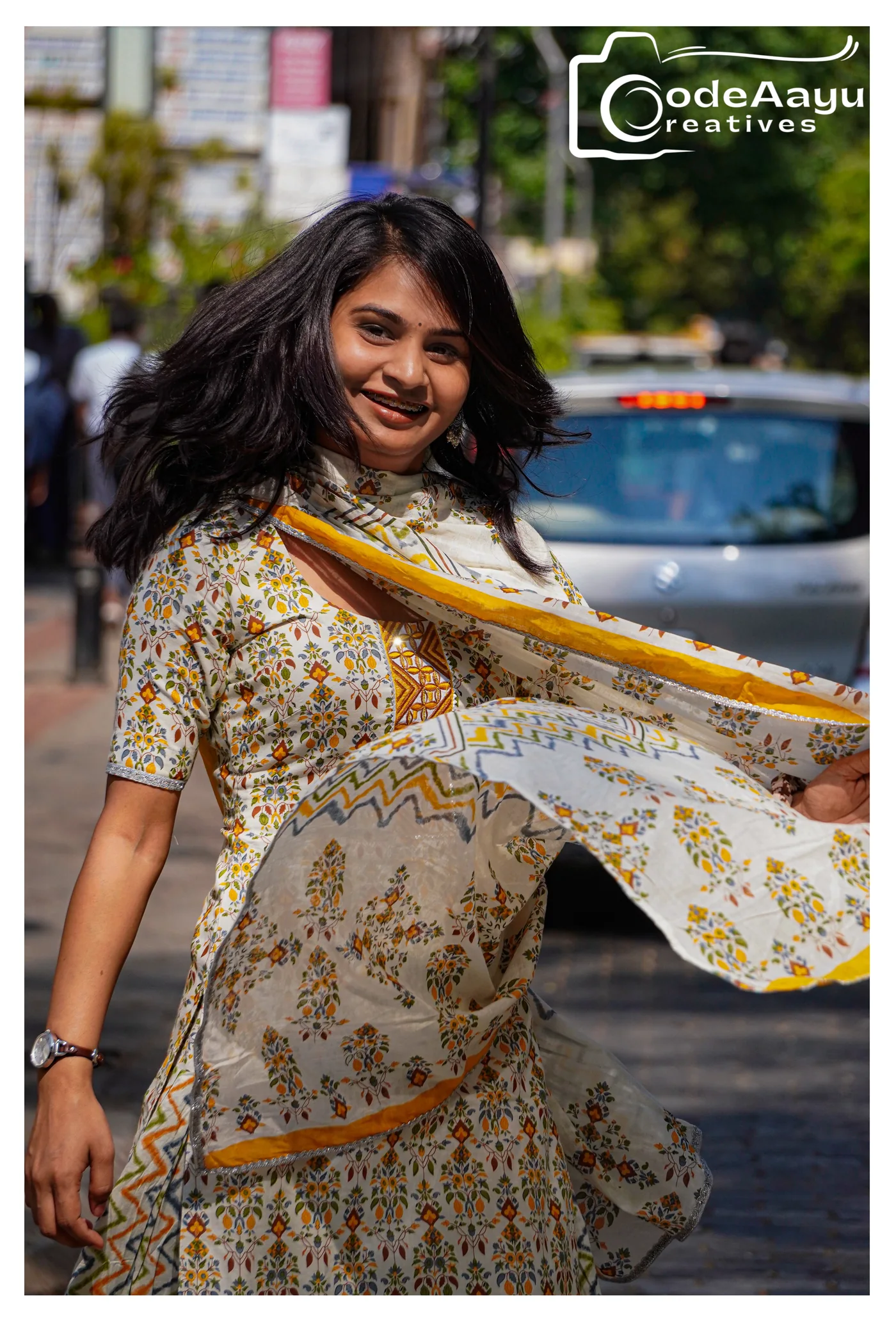 Kajal smiling as her printed outfit moves through the frame